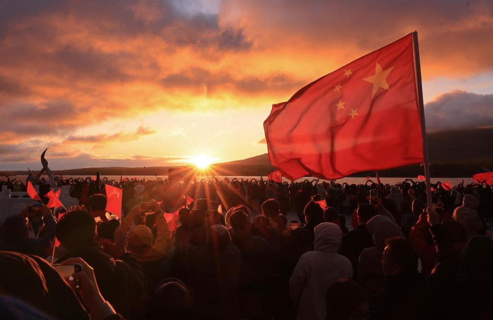 10月1日，人们在我国陆地最东端的黑龙江省抚远市迎接朝阳。新华社发（李拥军 摄）