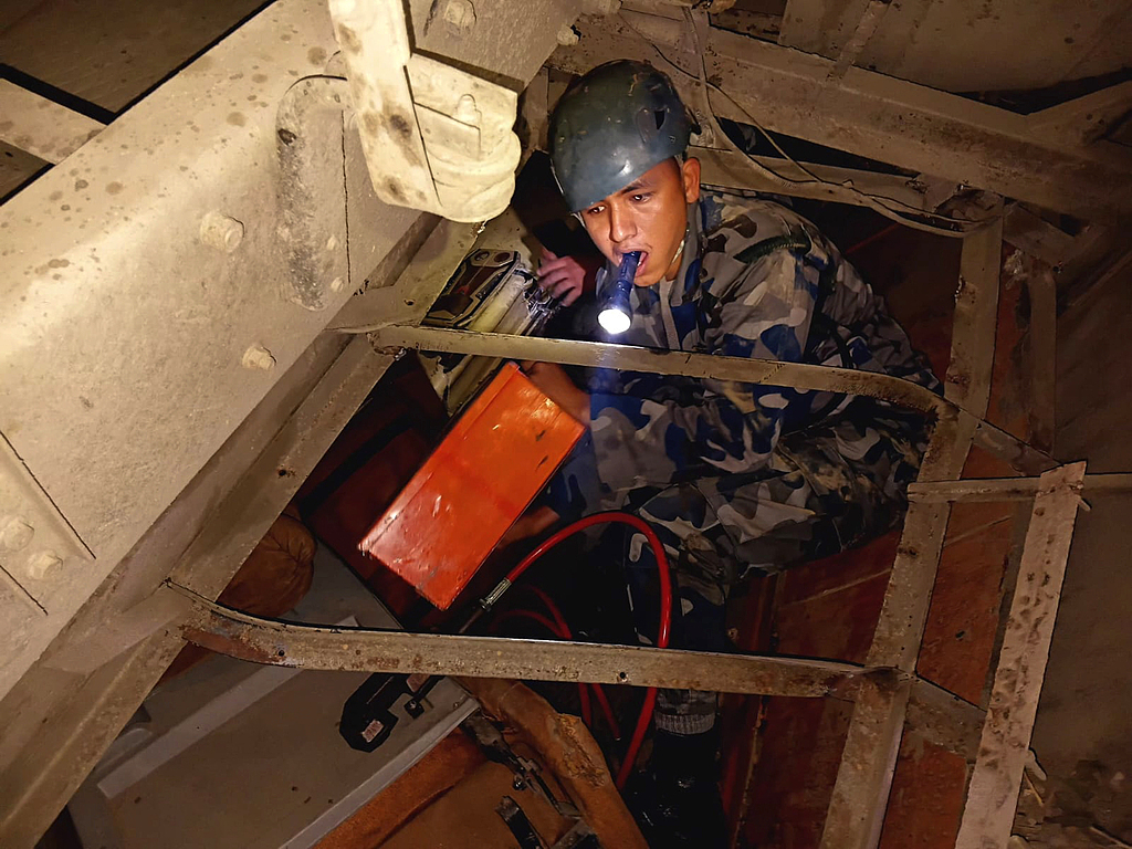 尼泊尔武装警察部队的救援人员在巴士事故现场搜救遇难者遗体和伤者。