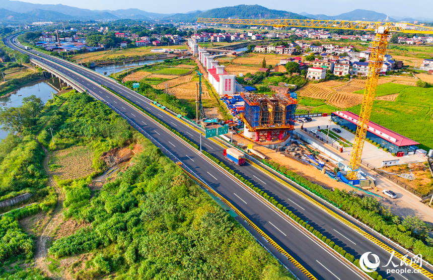 萍乡市上栗县金山镇的栗水河特大桥建设现场,塔吊林立,工业作业繁忙,基桩浇筑有序推进。人民网记者 朱海鹏摄