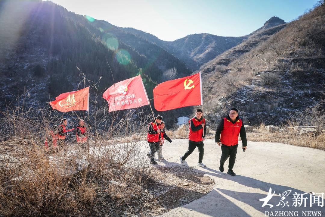 山路蜿蜒，大家互相鼓励上山进村。