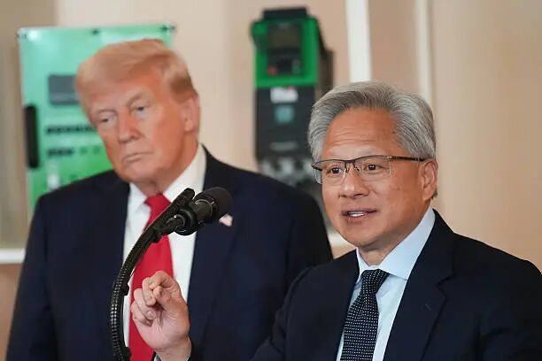President Donald Trump listens as Nvidia CEO Jensen Huang speaks in the Cross Hall of the White House during an event on 