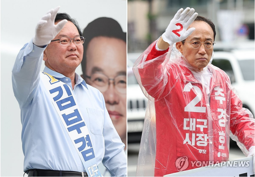 △6月2日，共同民主党大邱市长候选人金富谦（左）和国民力量党大邱市长候选人秋庆镐。（图源：韩联社）