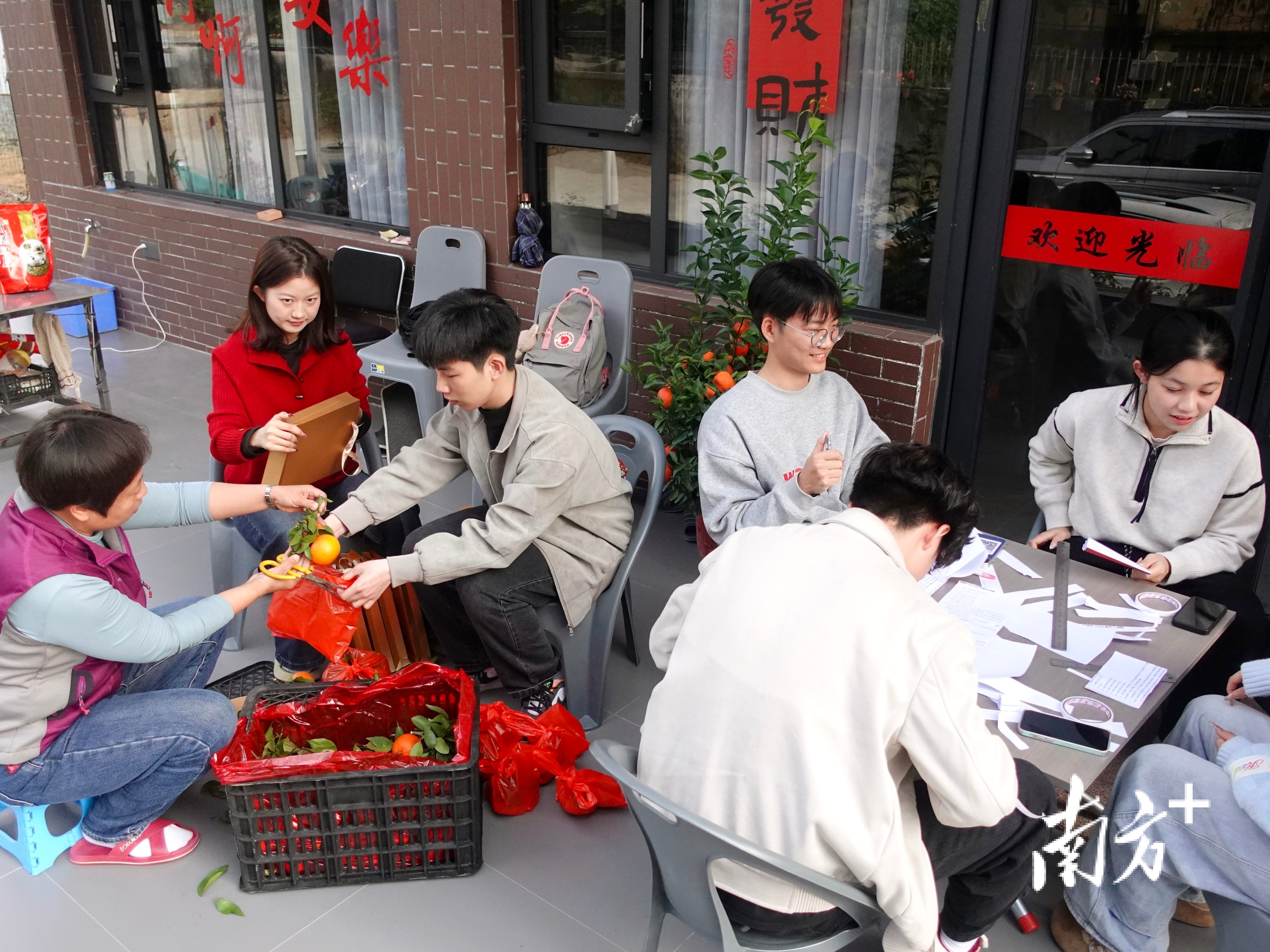 大年初三,大学生们在制作主持人手卡、包装礼盒。