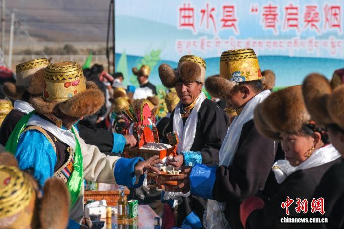 3月16日上午,拉萨市曲水县达嘎镇色达村村民举行传统春耕仪式,这是村民们在互敬切玛(藏历新年吉祥物)和青稞酒。中新社记者 江飞波 摄