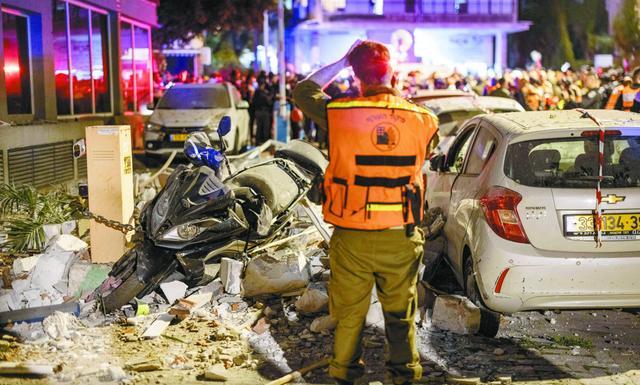 当地时代18日，以色列侦探与急救东谈主员在毗邻特拉维夫的拉马特甘一处遭伊朗导弹伏击的公寓楼现场开展责任。（视觉中国）