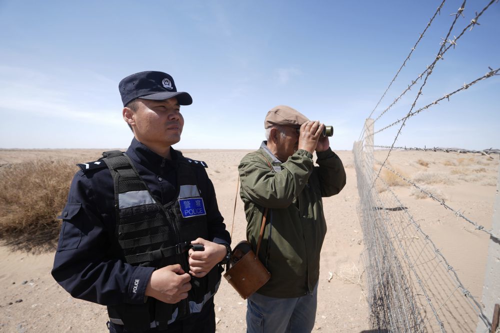 全国优秀共产党员尼玛老人的孙子宝泉（左）同父亲哈达布和一起巡边（资料照片）。尼玛老人与风雪、沙尘较量，守护着祖国的边境数十载。如今，她的儿子哈达布和、孙子宝泉陆续接过“接力棒”，一家三代接力守边。新华社发