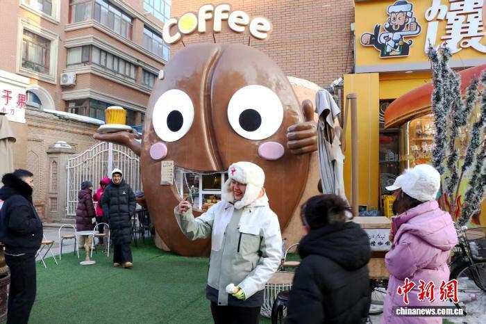 1月12日，在位于乌鲁木齐市的新疆国际大巴扎内，游客在“馕咖啡”摊位前拍照打卡。　苟继鹏 摄