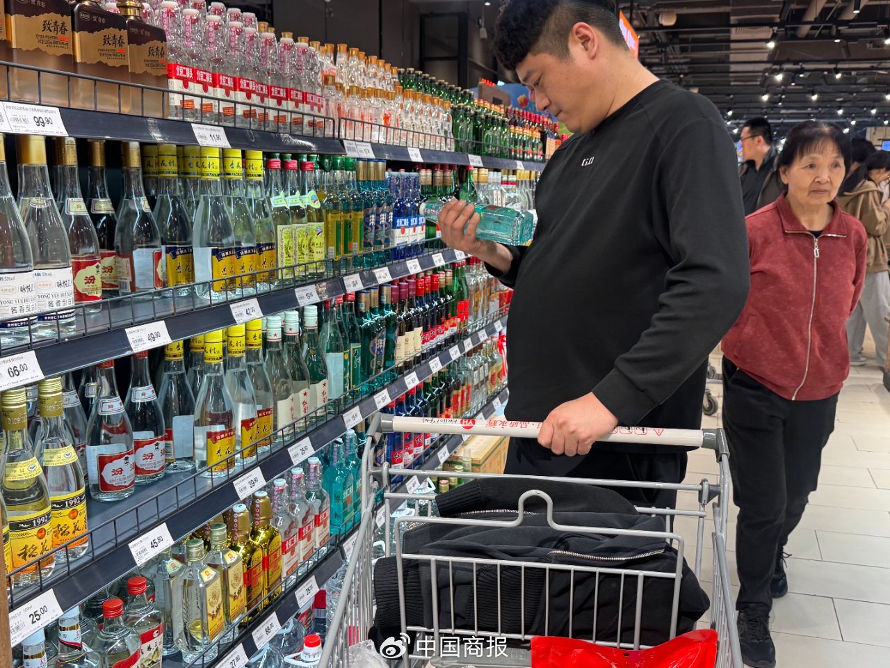 花费者在选购白酒居品。