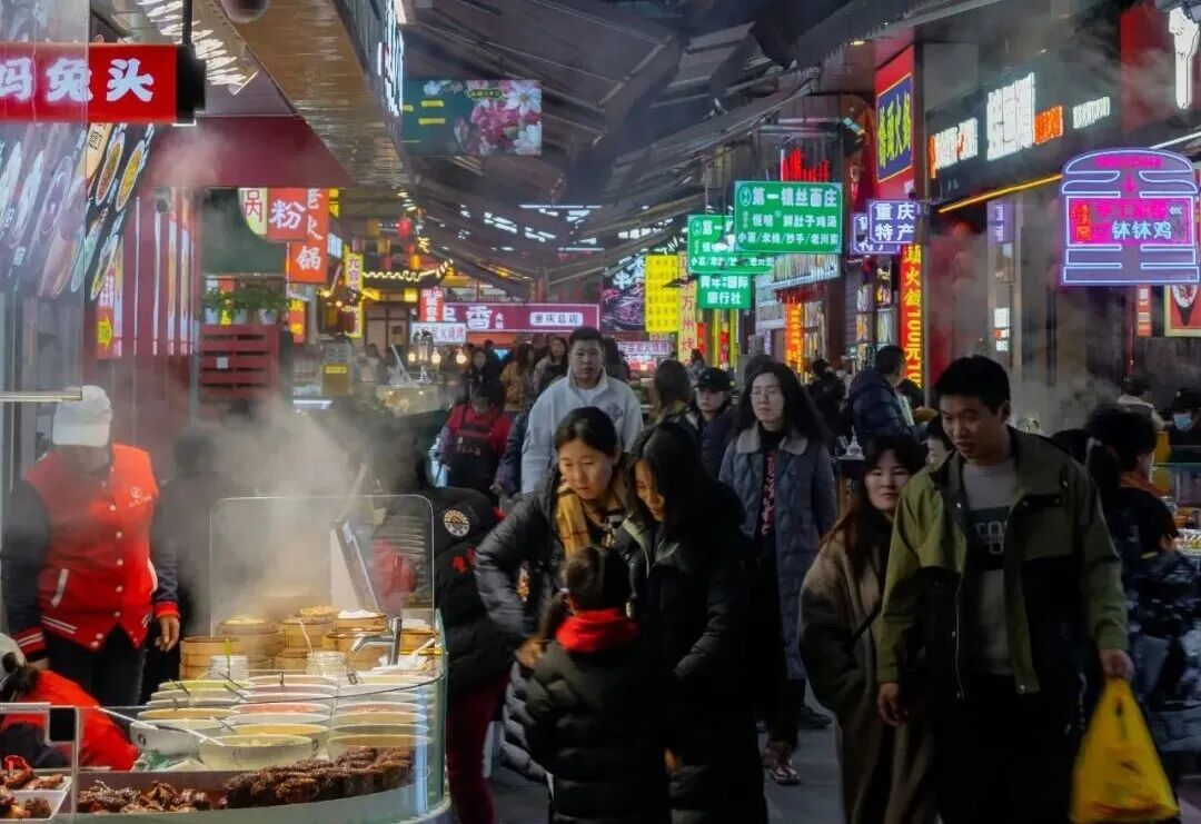 a group of people standing around a food stand