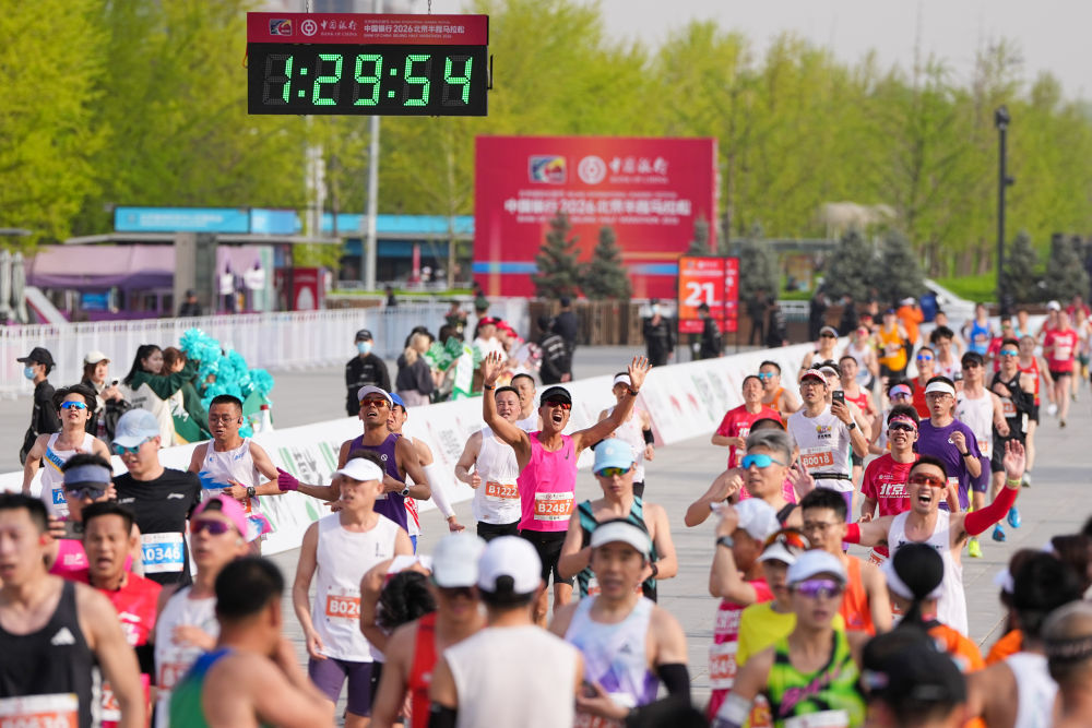 4月12日，2026北京半程马拉松参赛选手通过终点。新华社记者 鞠焕宗 摄