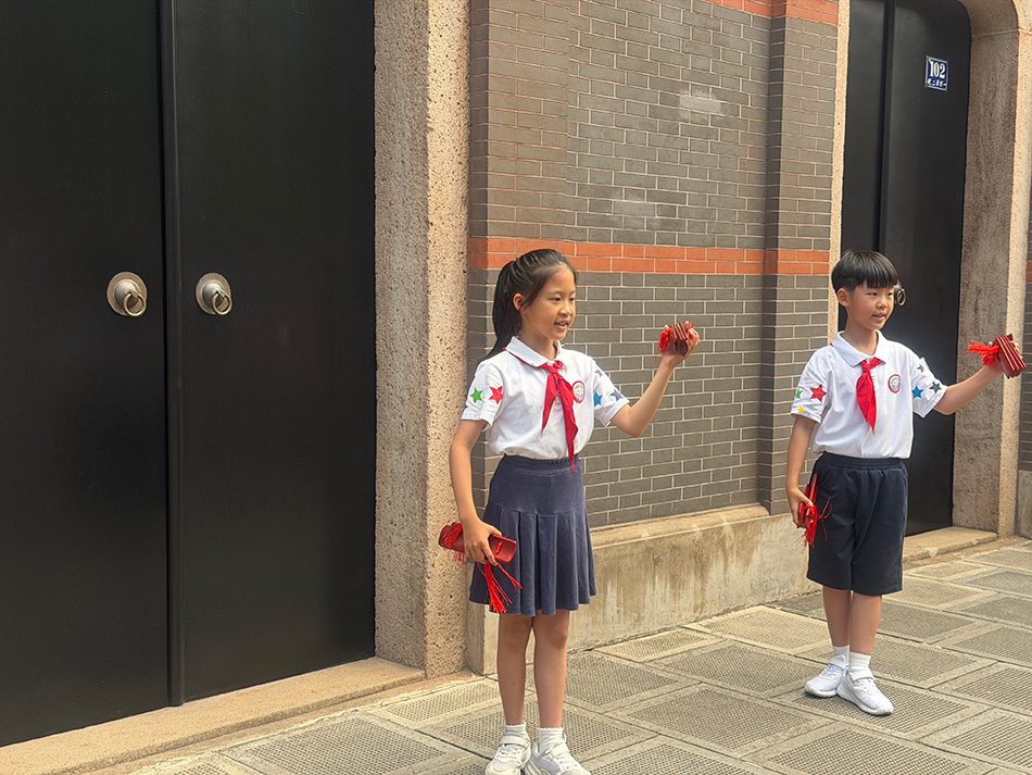 6月1日,“红领巾”小讲解员在一大会址前用快板讲述建党故事。 澎湃新闻记者 邹娟 摄