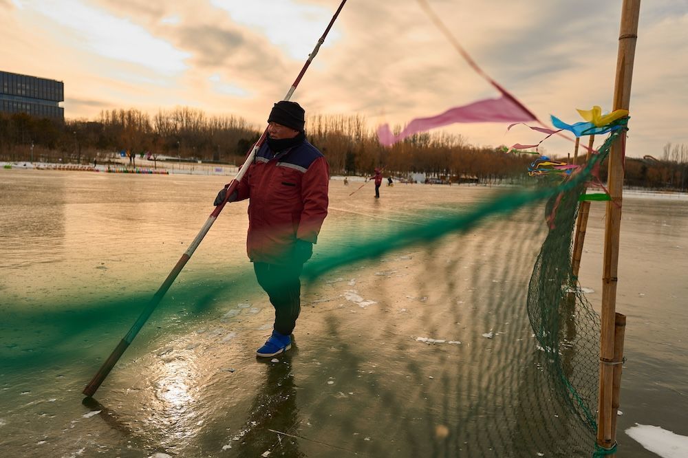 2026年1月18日，奥森公园冰场，刘彪扛着标杆在冰面上巡查风险点。