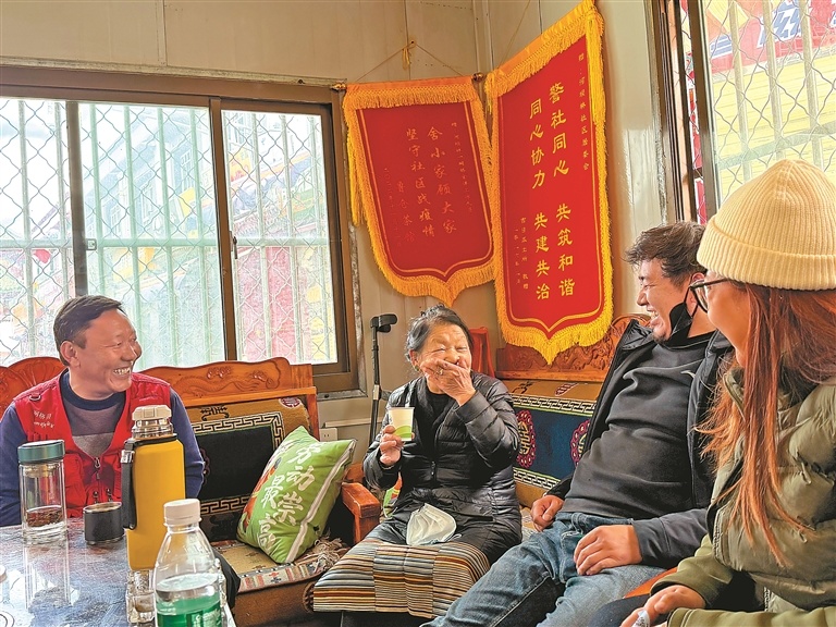 哈里玛老人（左二）和社区工作人员闲话家常。记者 明吉 摄