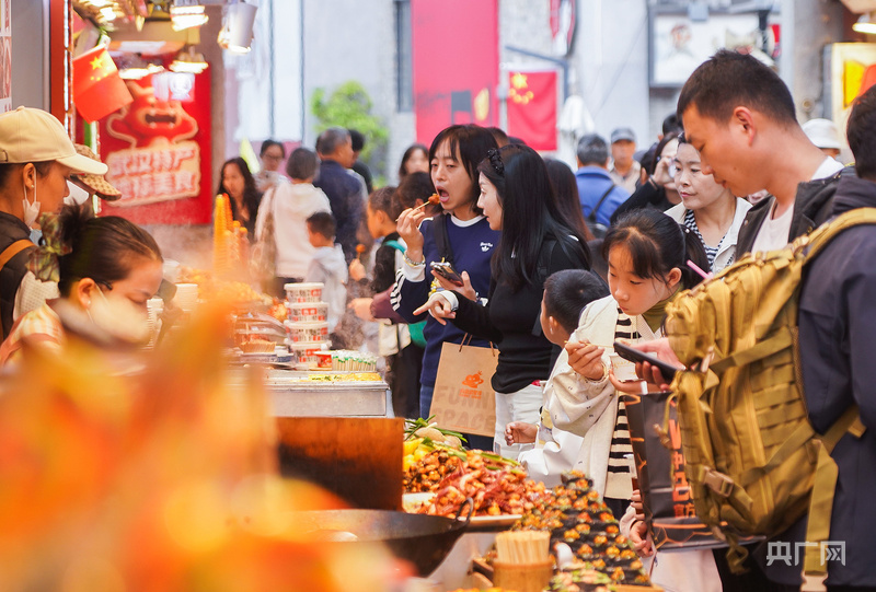 国庆假期，众多游客在户部巷品尝美食。