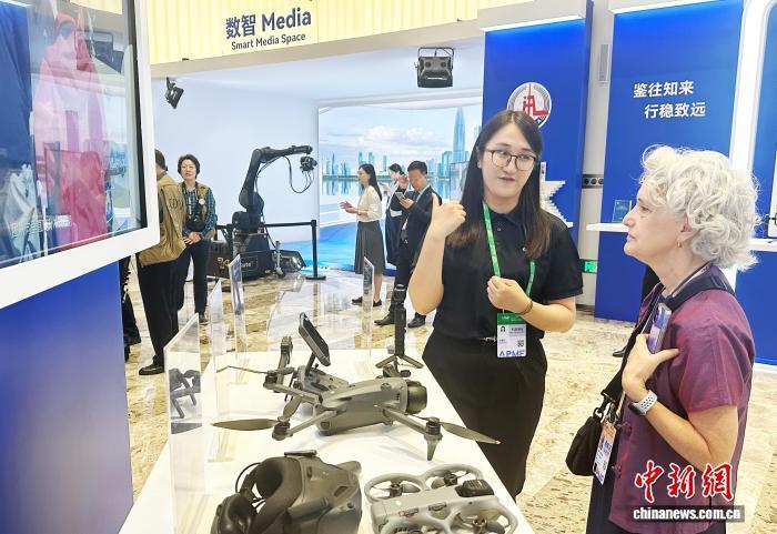 参会嘉宾正在了解无人机等产品。记者 程景伟 摄