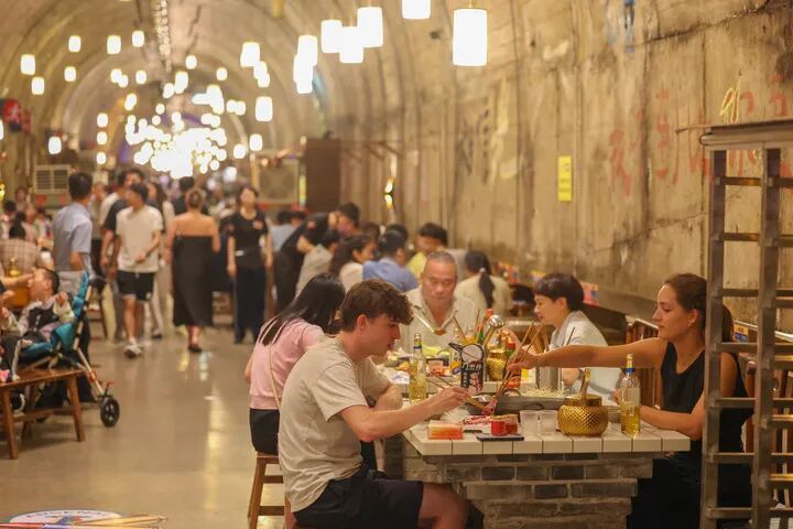 8月10日，在重庆市两江新区地下之城火锅店，游客在防空洞内吃火锅。
