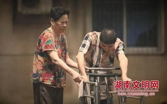 （彭连清老人搀扶着养子。图片来源：湖南文明网）