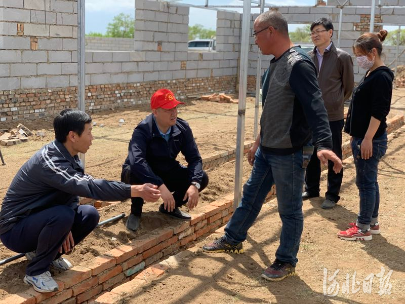 康保县马鞍架村驻村工作队和村民研究扩建养猪场事宜（资料片）。通讯员李丽坤摄
