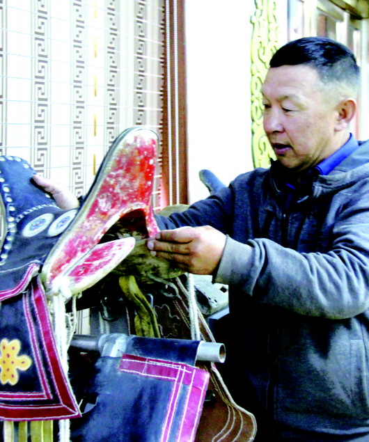 牧民查看收藏的银马鞍