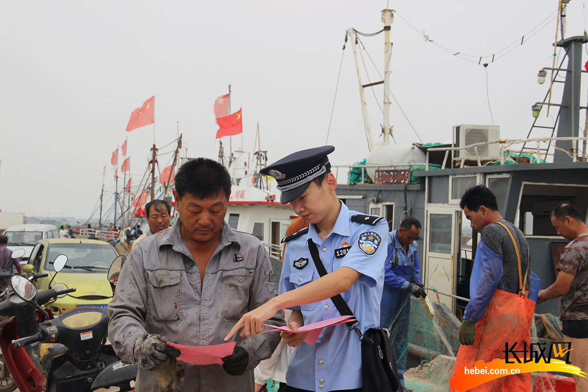 河北省公安厅海防管理总队沧州支队黄骅大队民警对辖区渔民进行法律宣传。