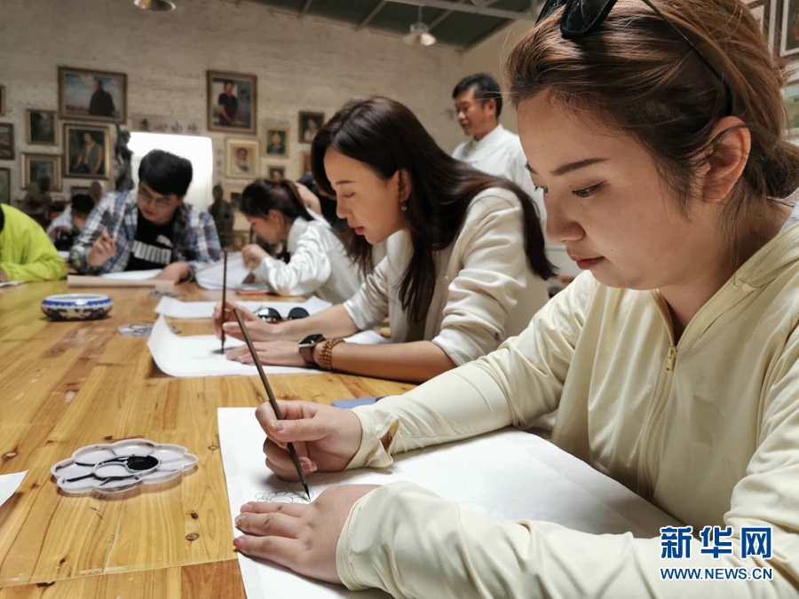 游客正在莫高里工匠村临摹壁画 新华网发（黄文新 摄）