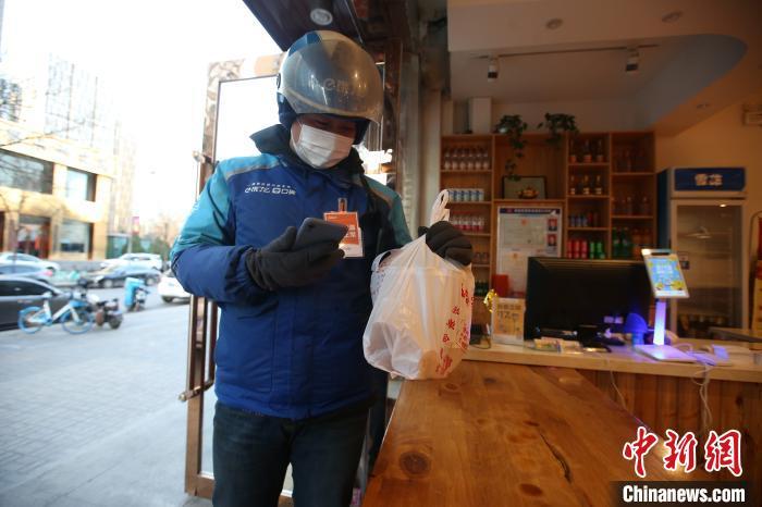 资料图:“饿了么”外卖员正在取餐。 张云 摄