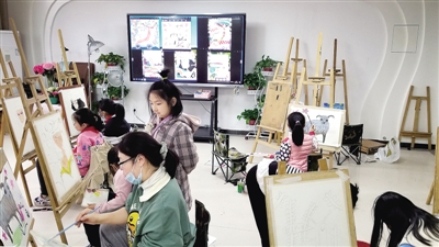 金水区艺术小学课后美术社团老师在指导学生画画