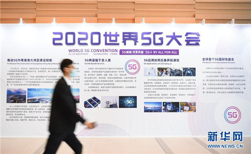 11月26日，参观者从2020世界5G大会展板前走过。当日，2020世界5G大会在广州开幕。大会包括主论坛和10个高峰论坛。大会期间，全球信息通信领域科学家、知名5G服务提供商和5G行业应用商将围绕5G领域的前沿技术、产业趋势、创新应用等方面开展交流与讨论。新华社记者邓华 摄