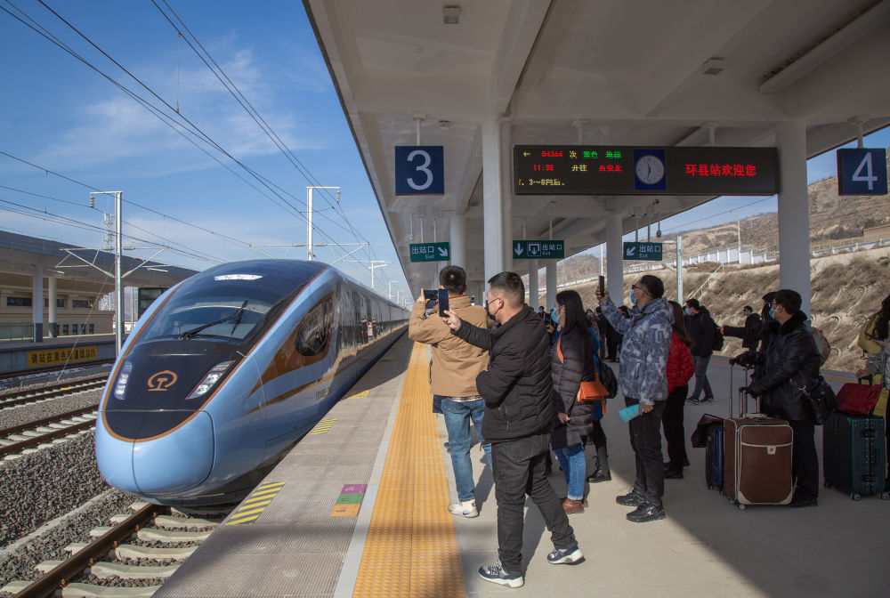 2020年12月26日,在银西高铁甘肃环县站,旅客准备乘坐动车组列车.