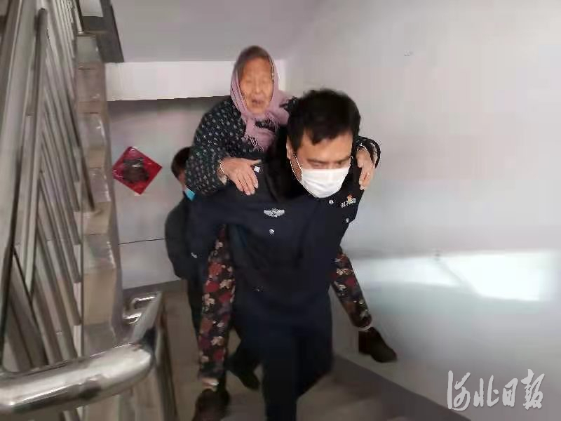 1月6日，赞皇县公安局民警陈海峰将一位80多岁老奶奶从7楼背到核酸检测点，又背回家中。 通讯员付朝霞供图