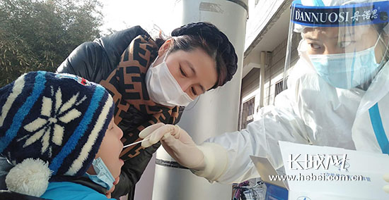 医护人员为一位小朋友采集咽拭子.祝雪娟 摄