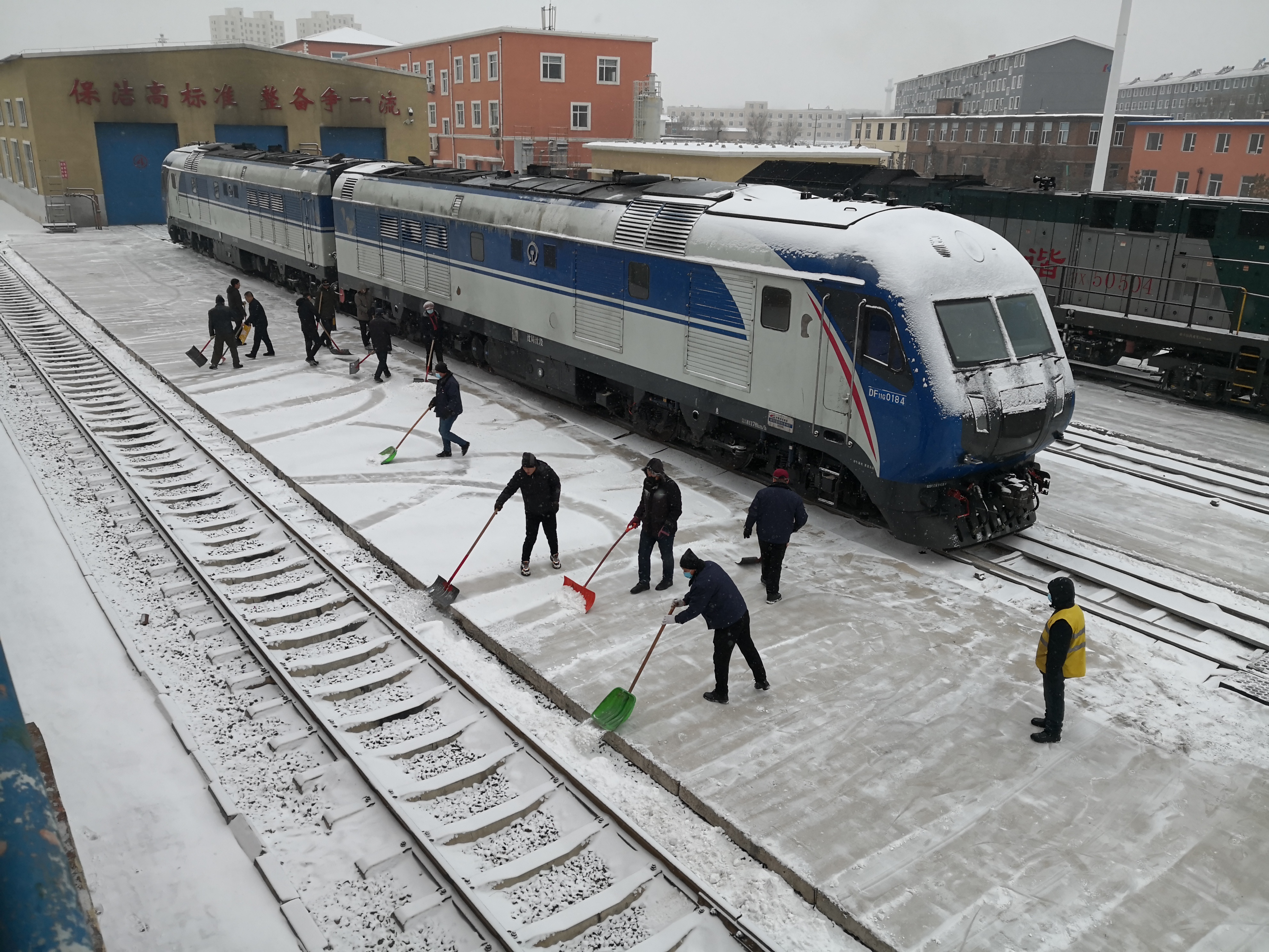 中国铁路沈阳局梅河口机务段职工清扫积雪.