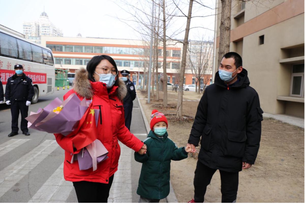 图为北京清华长庚医院分队队员张晓婷4岁的儿子和丈夫来院接她回家 杨欣/摄