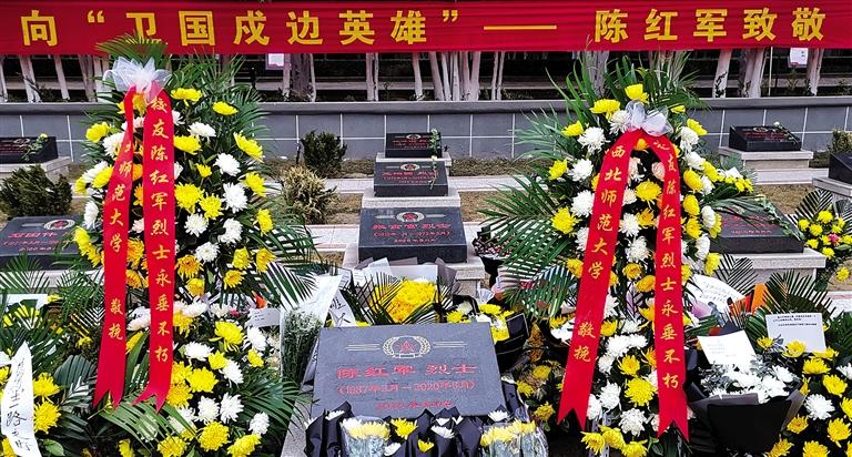 烈士墓碑被鲜花簇拥