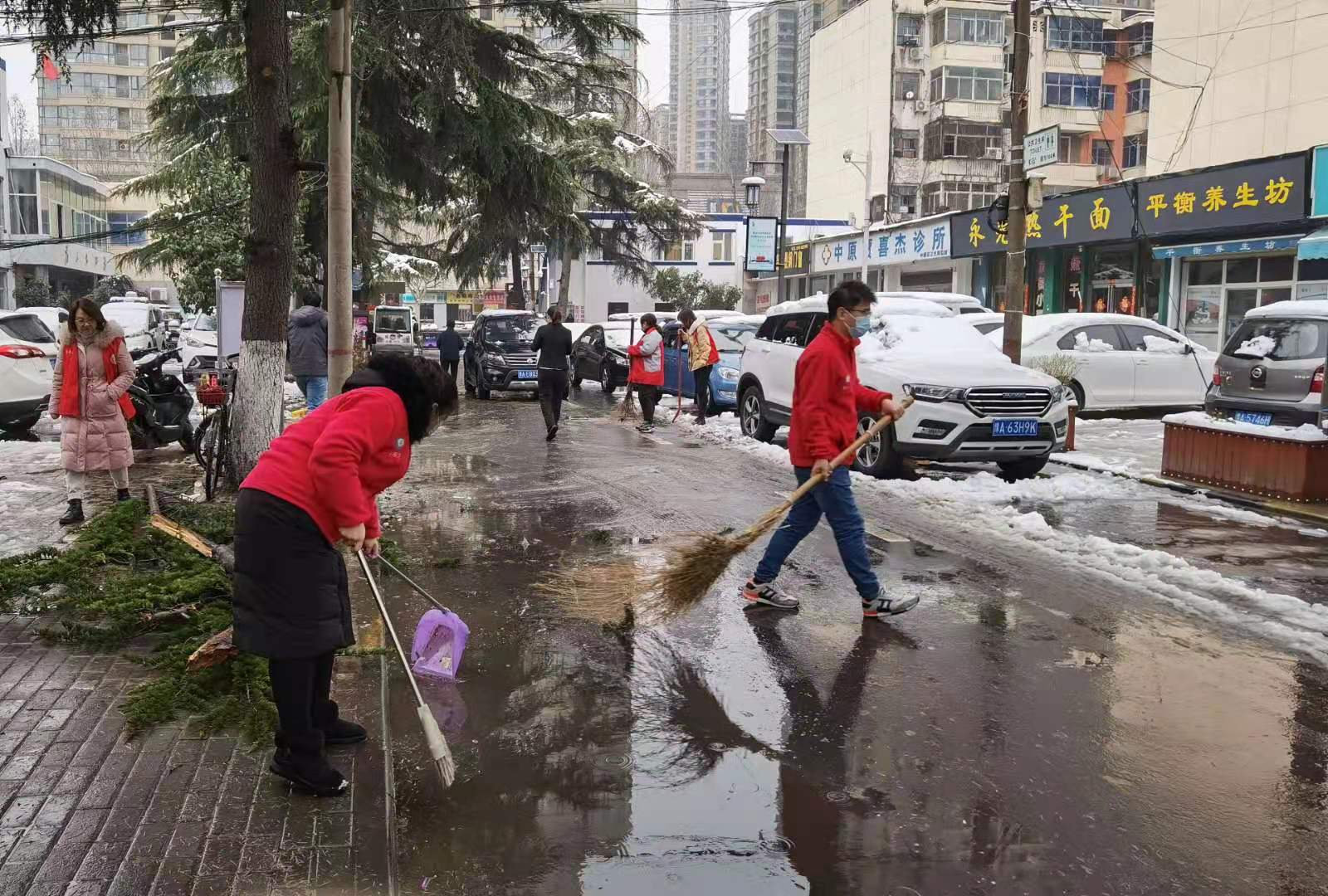 社工、志愿者一起清扫积雪