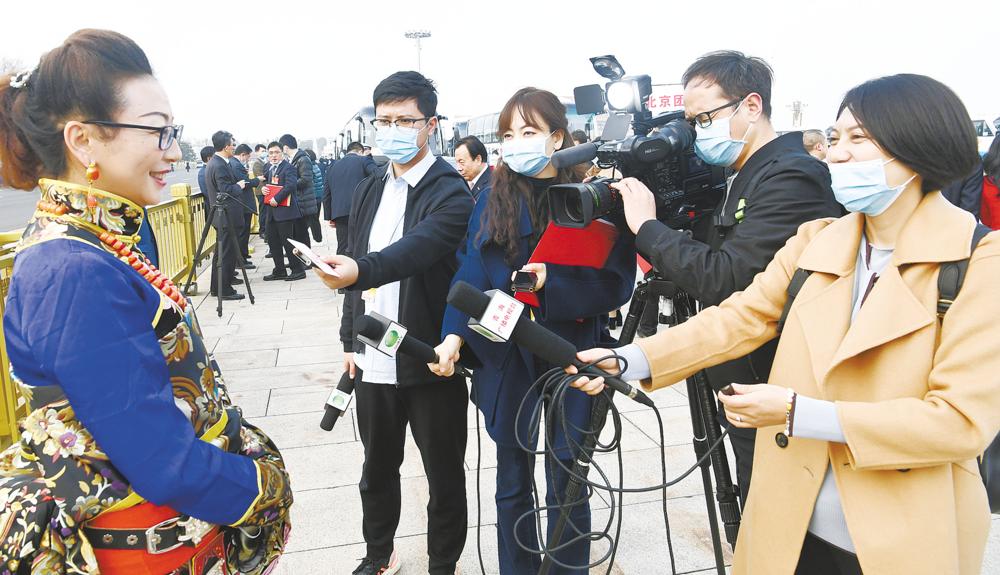 青海代表团随团记者正在现场采访.本报记者 祁国彪 摄