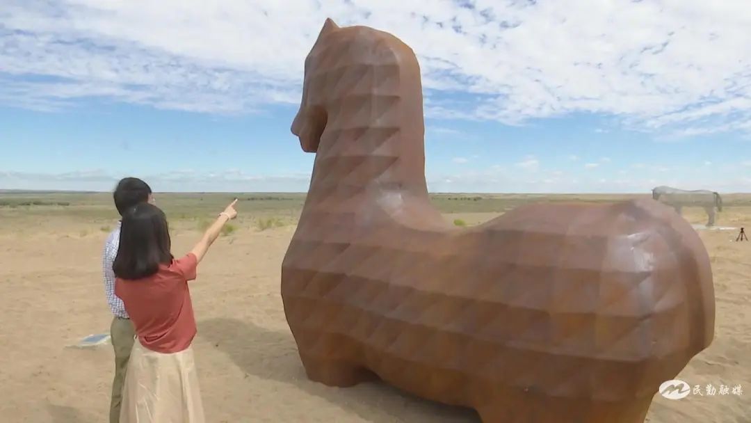 游客在欣赏沙漠雕塑 李异炳 摄