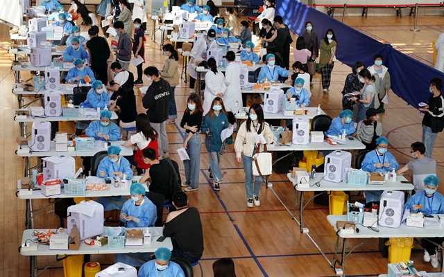 3月28日,在华东师范大学闵行校区体育馆内,师生们在接种新冠疫苗。新华社