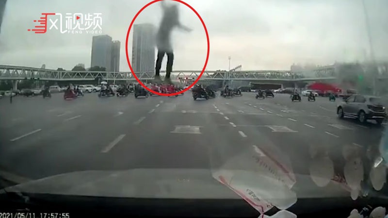 司机正在等红灯，亲眼目睹坠桥者砸在自己面前