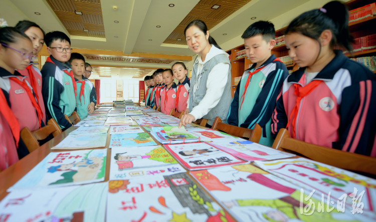 2021年5月12日，河北省秦皇岛市抚宁区金山学校学生在参观该校举办的红色经典故事绘本创作展。