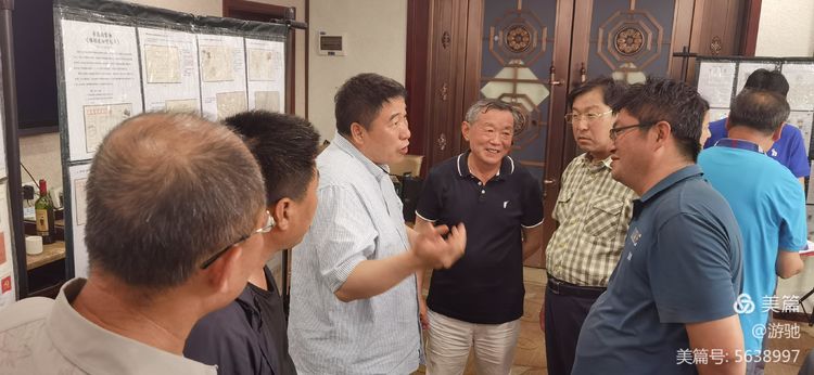 杨宏书会长（左三）与集邮专业委员会副主任李政（右一）等会员交谈收藏感受。