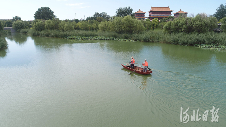 2021年8月2日，在河北省唐山市丰润区，水上保洁员在还乡河水面上清理漂浮物。