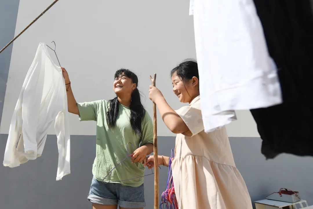 在宽敞的新家院子里晾晒衣服