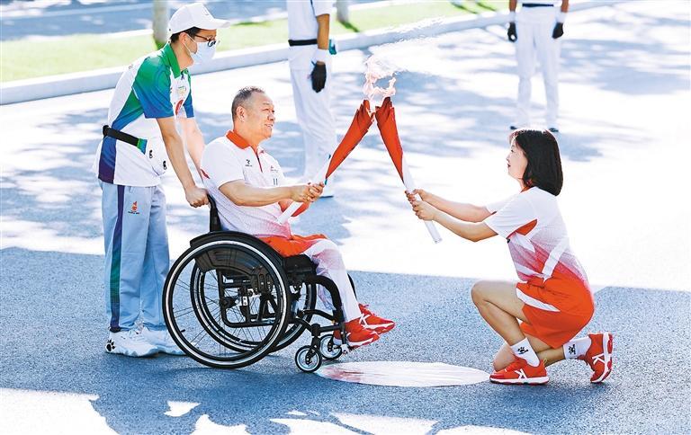 ▲▲9月12日，十四运会和残特奥会火炬传递活动中，火炬手们交接火炬。 （西安报业全媒体记者 谢伟 摄）