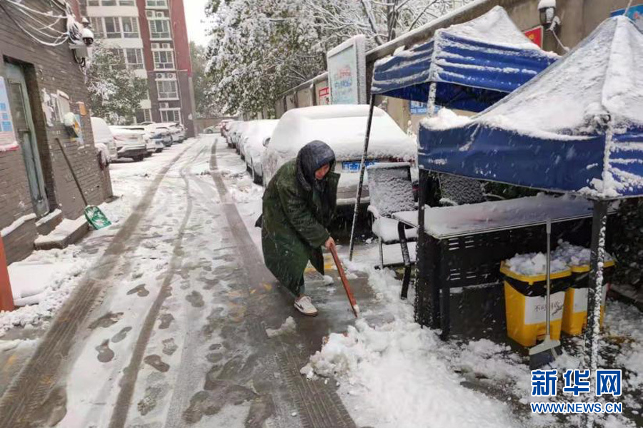 雄安新区安新县征迁办防疫执勤人员在打扫包联社区积雪。安新县融媒体中心供图