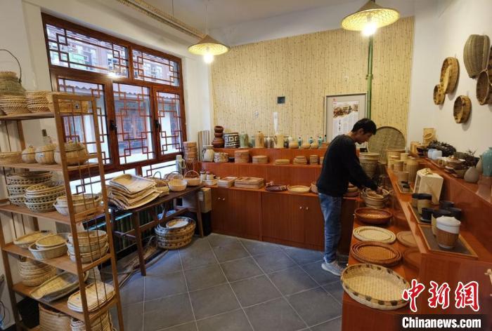 图为竹编手艺人张照杰整理其满屋子的竹编工艺品。 冯志军 摄