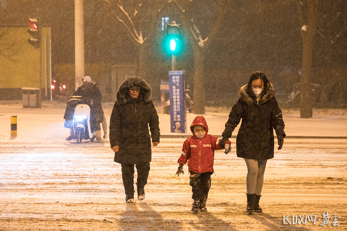 路边行人顶着大雪前行。长城网·冀云客户端记者 李皓 摄