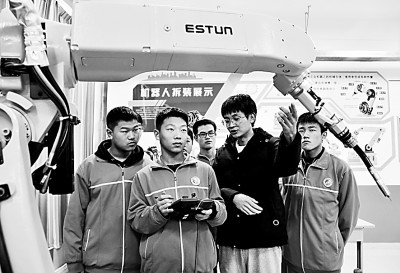 2021年11月25日，河北省邯郸市永年区职教中心的学生正在老师的指导下进行工业机器人实践操作。胡高雷摄/光明图片