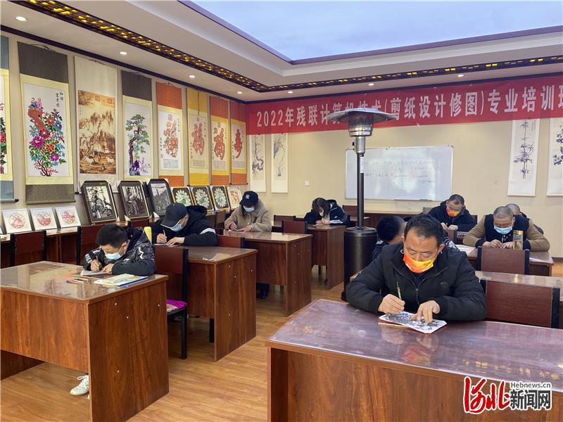 蔚县“阳光家园残疾人剪纸培训基地”里正在进行剪纸培训。河北日报记者赵杰摄