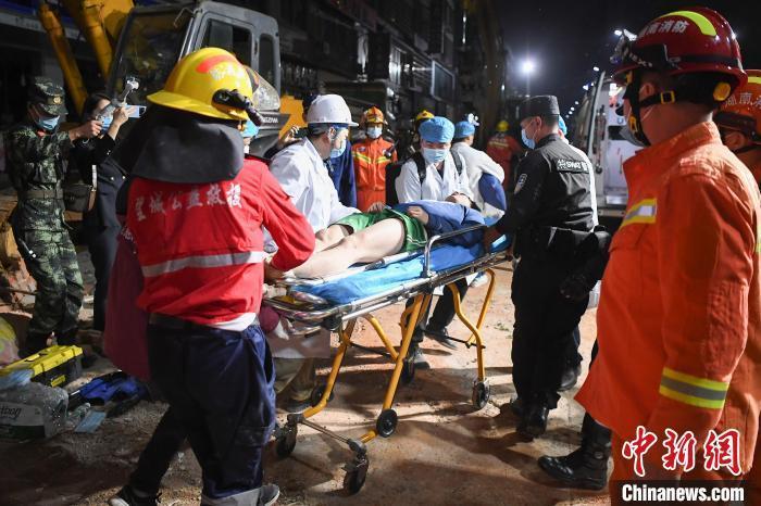 4月29日23时许，救援人员将一名获救的被困者送上救护车。杨华峰 摄
